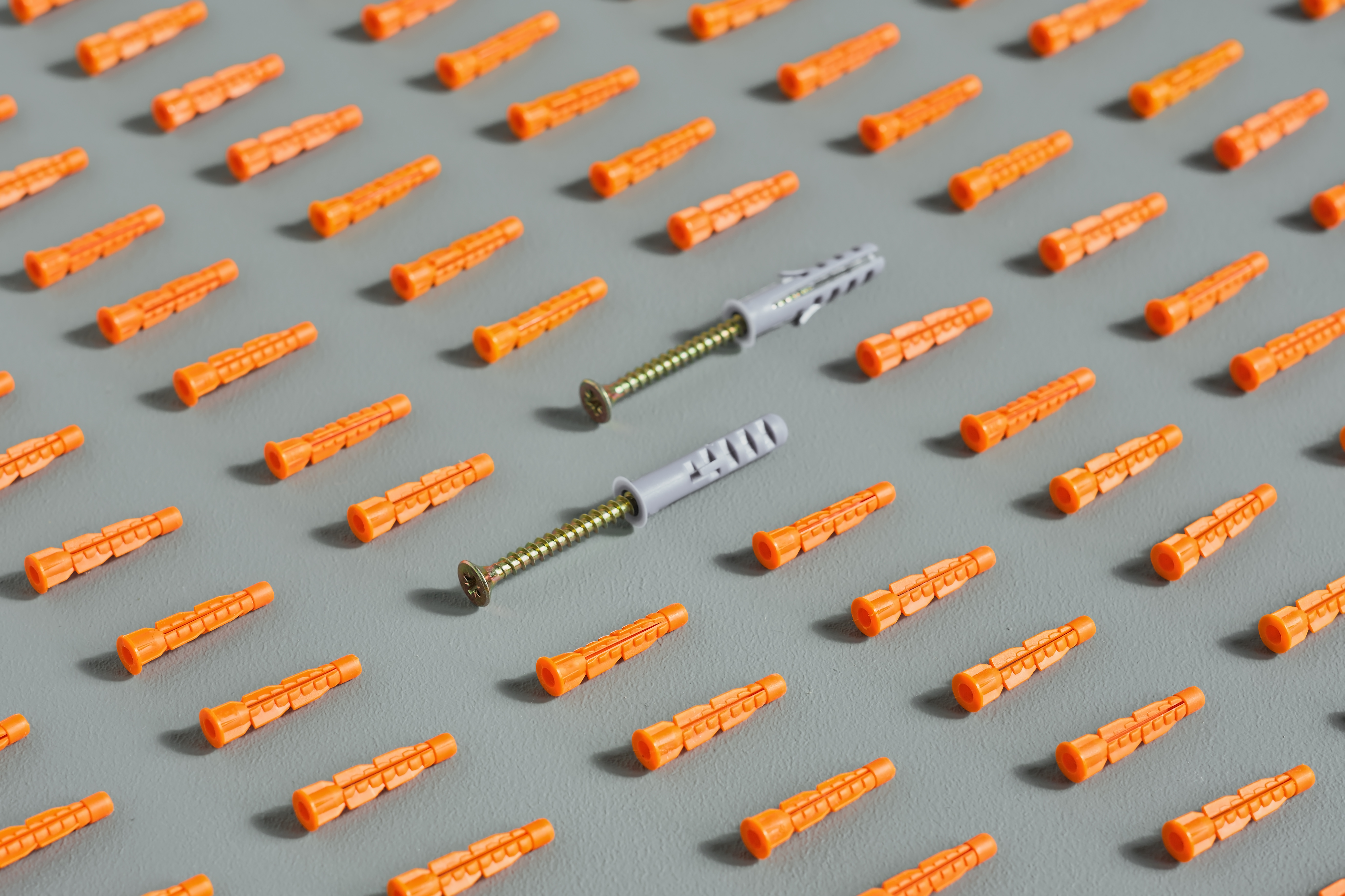 seamless-pattern-of-red-plastic-dowels-on-gray.jpg